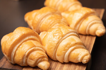 Fresh croissants on a wooden board. Fresh bakery croissants.selective focus.