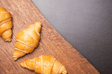 Fresh croissants on a wooden board. Freshly baked with copy space.top view croissant.