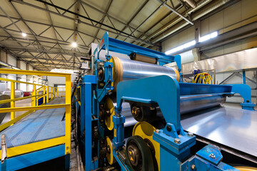 Photo of steel roofing forming machine. Industrial machine for metal sheet roof coils cut. Process...