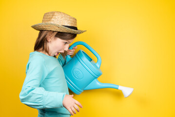 Surprised little gardener girl using a watering can © Egoitz