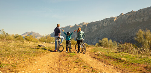 happy family biking in countryside- Spain,  Andalusia