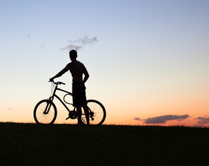 Fototapeta na wymiar silhouette of a cyclist on the sunset