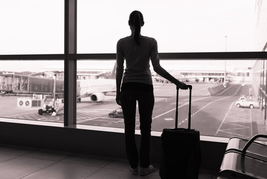 silhouette of a person with a suitcase at the airport