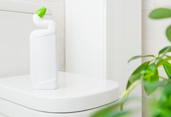 White plastic bottle with bathroom disinfectant gel on toilet bowl