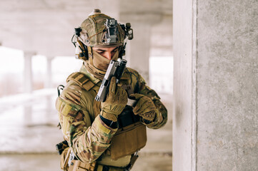 Special forces operator wearing Multicam uniform and his handgun xdm 9mm while practicing CQB...