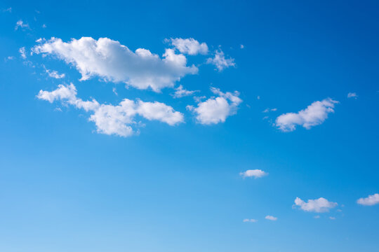 Sky replacement in illustration and photo. Beautiful fluffy clouds in a clear blue sky.