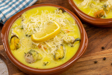 scallop gratin and mold on a wooden board