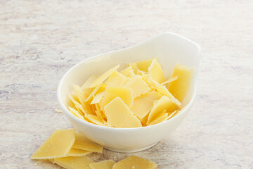 Sliced parmesan cheese heap in the bowl