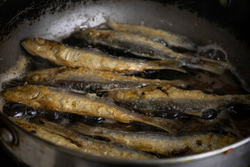 Fried herring on a frying pan.