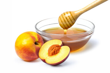 Fresh peach fruit and honey in glass bowl isolated on white background.