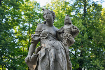 Fototapeta na wymiar Sandstone statues in the Saxon Garden, Warsaw, Poland. Made before 1745 by anonymous Warsaw sculptor under the direction of Johann Georg Plersch. Statues of Greek mythical muses