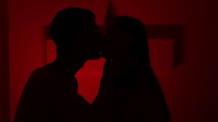 Couple kissing in the red room - Powered by Adobe