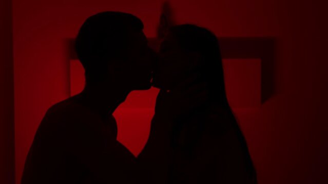 Couple kissing in the red room