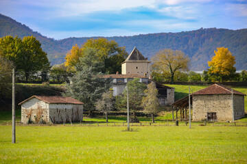 Obraz premium Beautiful autumn landscape at French countryside, farm and houses, Loures-Barousse, Pyrenees, France