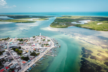 Aerial landscape overlooking the city of Rio Lagartos. The city is surrounded by a beautiful river with azure water. Fishing boats are moored to the shore. Yucatan, Mexico