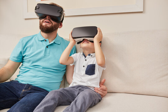 Father and son experiencing cyberspace in VR glasses