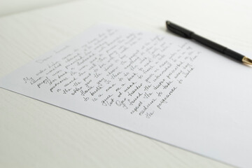 Fototapeta premium A sheet of writing with a pen on the table.