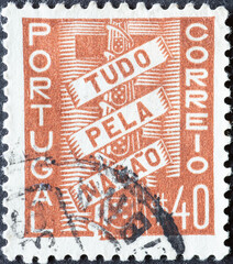 Portugal - circa 1935: a postage stamp from Portugal, showing a Coat of Arms with Scroll (Tudo pela Nação)