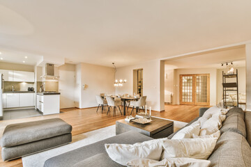 A luxurious living room with a huge gray sofa and decorative beige pillows