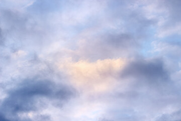 abstract blurry background textured by clouds illuminated by sunlight