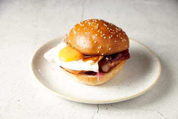 Egg and bacon roll on plate