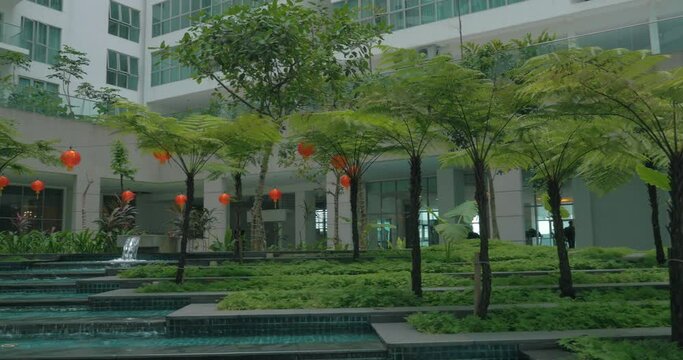View of picturesque garden with fountain against modern building. Kuala Lumpur, Malaysia