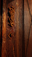 ancient wooden door with inverted keyhole and brass knocker located in the city of Tarsus Mersin province Turkey