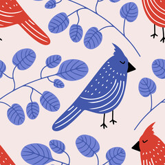 Vector seamless pattern with red and blue cardinal birds in tree branches