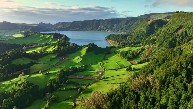 Azores nature on sunny day. Aerial shot of green meadows, mountains and Furnas lake on Sao Miguel Island, Azores, Portugal
