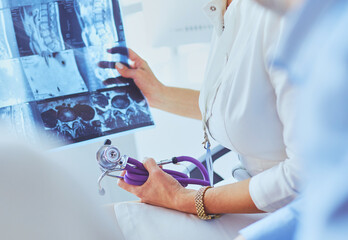 Medical doctor looking at a x-ray image in the office - 482810350