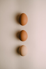 three chicken eggs on a white background