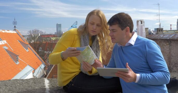 Couple looking at city map outdoor