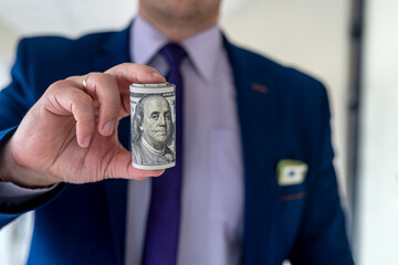 happy businessman holding lots of dollars after success deal