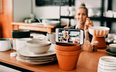 Showing the insights to my fans. Cropped shot of an attractive mature woman using her cellphone to record her pottery process for her blog.