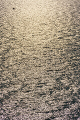 fishing boat, golden sunlight reflected in a waves at sunset, dark contrast background seascape, top view, beautiful sea