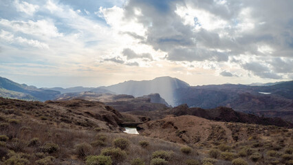 dam and reservoirs of the Canary Islands on the island of Gran Canaria in ravines of the island in a protected natural area with wild nature plants and native vegetation with beautiful lights, reflect