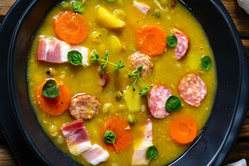 Hearty rustic pea soup with bacon and sausage