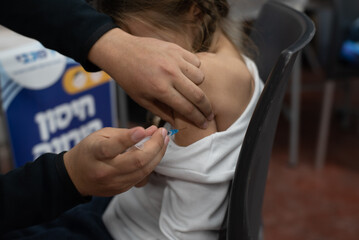 Small girl are being vaccinated against coronavirus. Injections are given to save life. Vaccination...