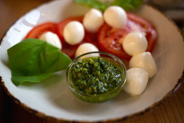 juicy fresh caprese salad with mozzarella tomatoes and pesto sauce