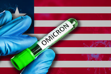 Liberia outbreak of omicron variant. Hand holds a test tube with covid-19 virus omicron in front of...