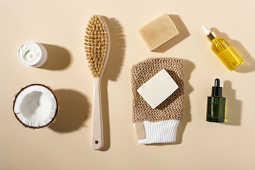 Fototapeta na wymiar organic natural cosmetics composition, soap, brush, oil, cream on beige background