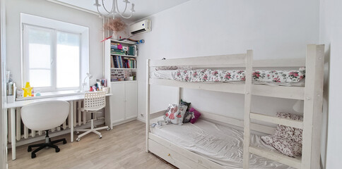 bunk bed and desktop in a bright children's room. 