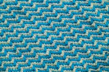 Texture of jacquard fabric with white blue geometric pattern.