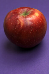 red apple on a purple background