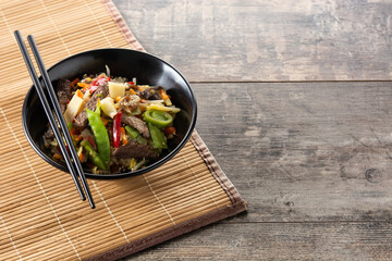 Beef, vegetables and sesame seeds on rustic wooden table.Copy space