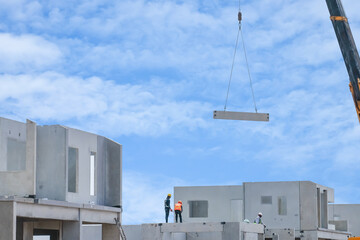 Construction worker are installing the precast concrete beam at housing estate, build a house,...