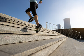 Fitness sports woman running up stairs in city