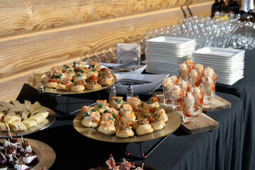 A treat for a buffet or a house party. The table is reserved for catering. Black tablecloths, hard light.
