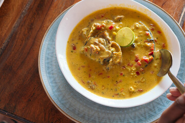 Top view of a plate of fish soup. Colombian food