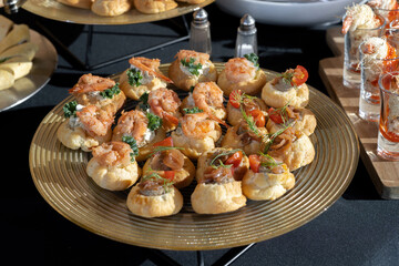 A treat for a buffet or a house party. The table is reserved for catering. Black tablecloths, hard light.